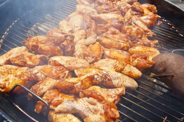 BBQ chicken wings cooking on a hot grill